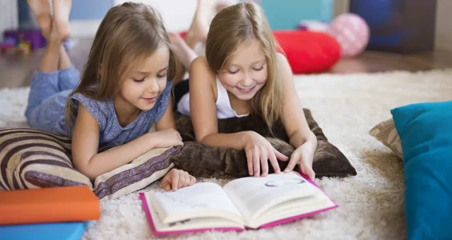 Reading interesting book with sister